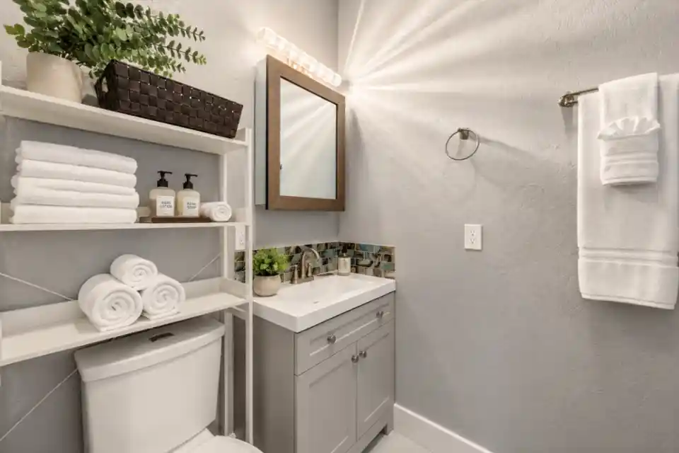 The Carriage Loft bathroom vanity with bright lighting and clean amenities in Sheridan WY