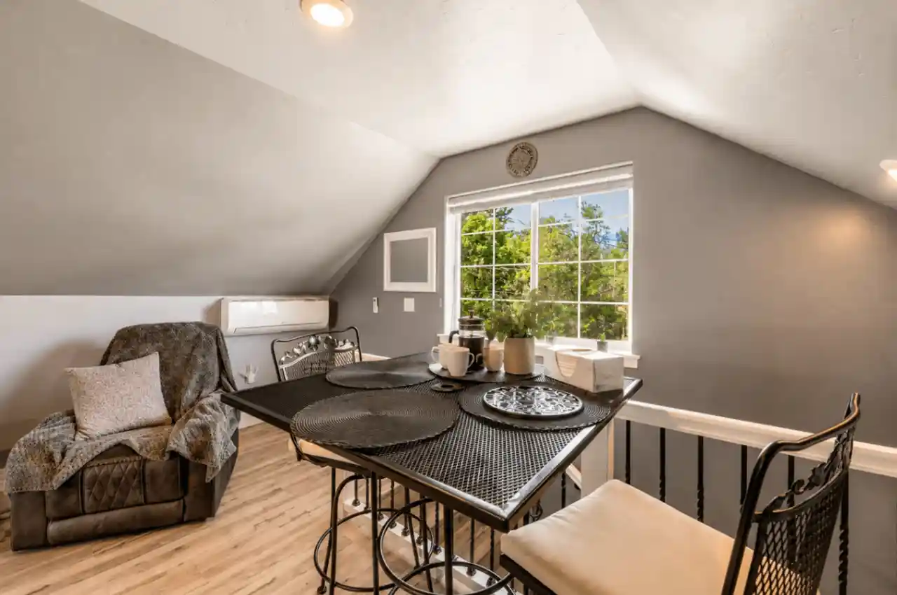 Loft dining nook at The Carriage Loft with window light and seating for a remote-work friendly stay in Sheridan