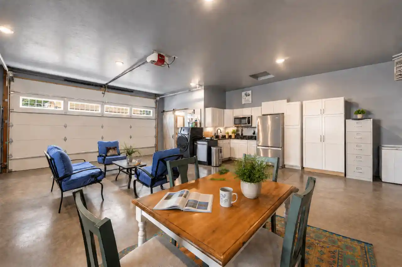 Open living area and kitchen at The Carriage Loft in Sheridan Wyoming with seating and dining table